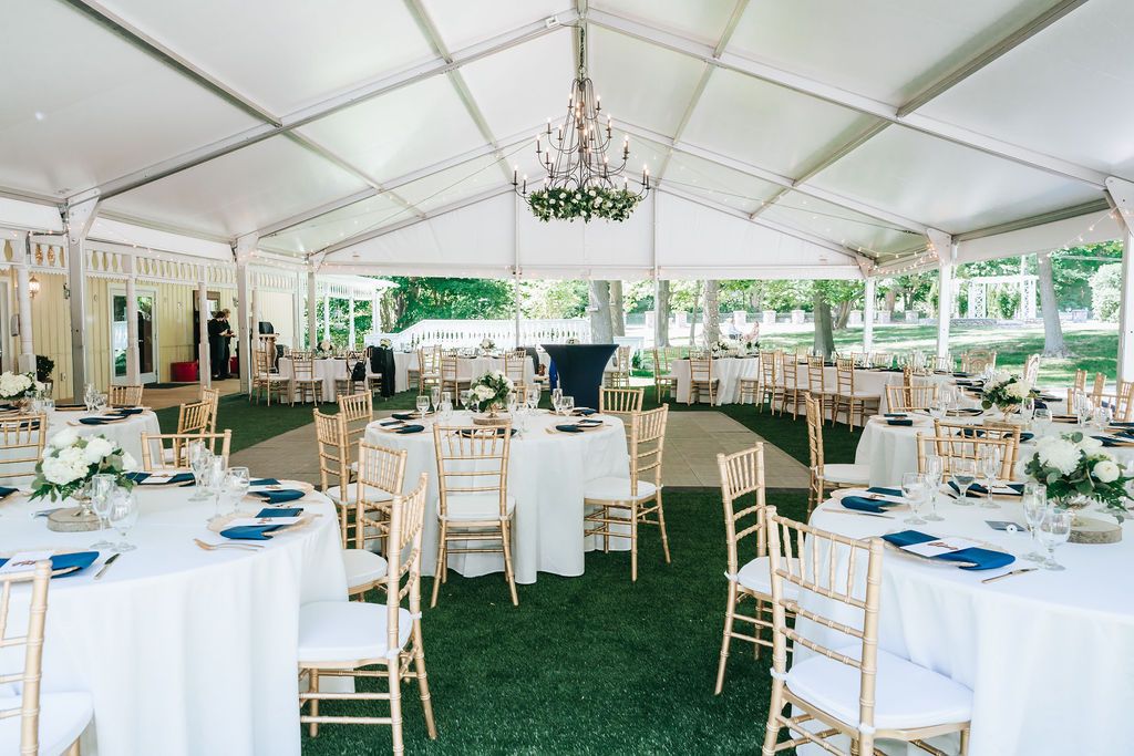 Stonegate Manor & Gardens Benton Harbor wedding venue - wedding tables with white tablecloths, blue napkins, and gold chairs