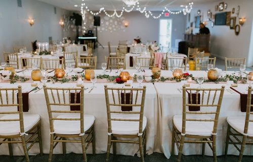 Stonegate Manor & Gardens Michigan wedding venue - wedding tables with gold chairs and autumnal candles